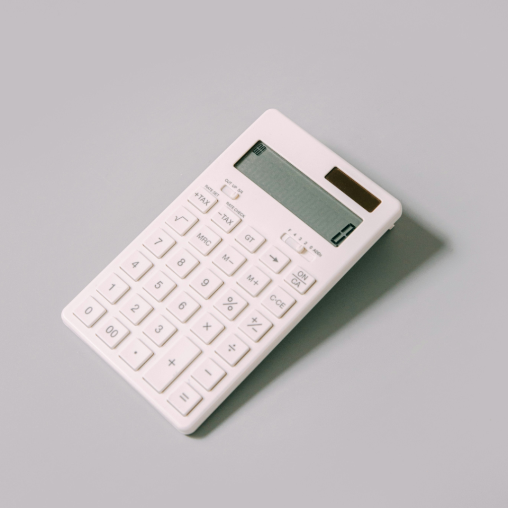 White calculator with a blank display on a light grey background.